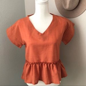 Burnt orange high/low peplum top